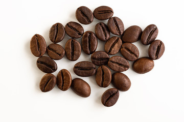 Coffee beans scattered on a white background top view