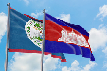 Cambodia and Belize flags waving in the wind against white cloudy blue sky together. Diplomacy...