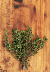 Thyme bunch on the wooden background. Top view, copy space for text.
