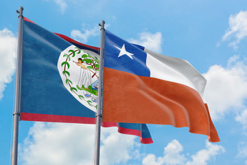 Chile and Belize flags waving in the wind against white cloudy blue sky together. Diplomacy...