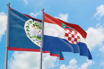 Croatia and Belize flags waving in the wind against white cloudy blue sky together. Diplomacy concept, international relations.
