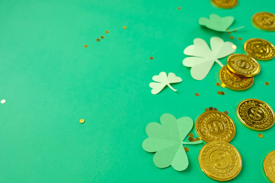 St. Patrick's day, clover and gold coins on a green background