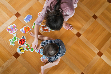 Mom and baby study insects. Mother teaches a child. View from above. Baby boy and insects. Flat lay