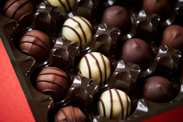Assorted chocolate truffle on red background 