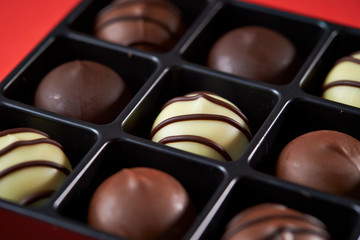 Assorted chocolate truffle on red background 