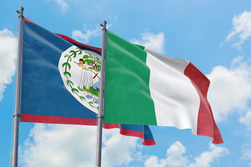 Italy and Belize flags waving in the wind against white cloudy blue sky together. Diplomacy...