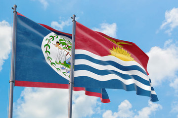 Kiribati and Belize flags waving in the wind against white cloudy blue sky together. Diplomacy concept, international relations.