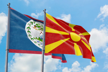 Macedonia and Belize flags waving in the wind against white cloudy blue sky together. Diplomacy concept, international relations.