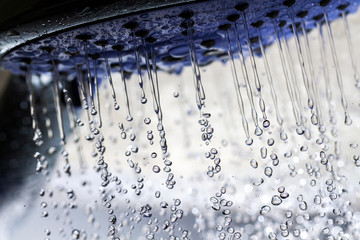 Fototapeta na wymiar Shower head and falling water drops.