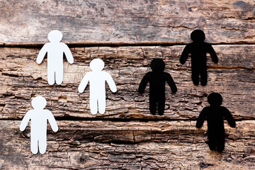 a group of male white silhouettes against a group of male black silhouettes stop racism concept