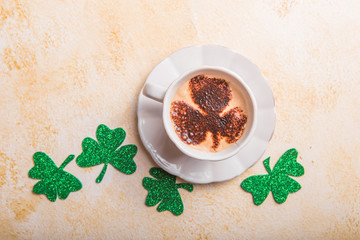 Happy Saint Patricks Day flat lay composition with card, coffee drinks, shamrock leaf clovers