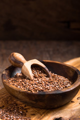 flax seeds or line  in bowl  on wooden background