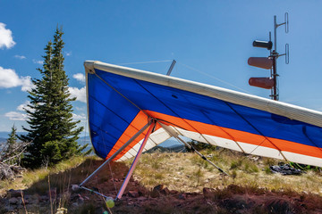 Extremal and risky hobby for braves. Paraglider on the hilltop. Hang Gliders ready to flight....
