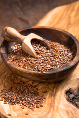 flax seeds or line  in bowl  on wooden background