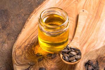 watermelon  seeds oil and raw seeds on wooden background.
