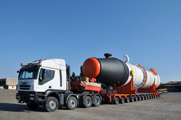 Oversize truck with multiple wheels and tank - obrazy, fototapety, plakaty