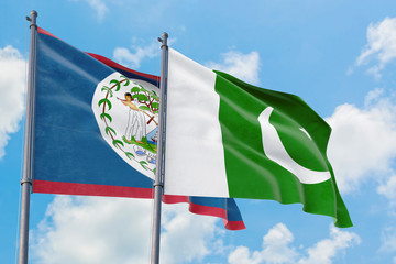 Pakistan and Belize flags waving in the wind against white cloudy blue sky together. Diplomacy...