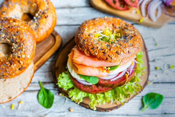 Bagel with salmon and fresh vegetables.