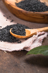 Black sesame seeds in the wooden spoon.