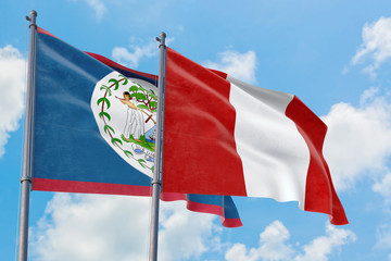 Peru and Belize flags waving in the wind against white cloudy blue sky together. Diplomacy concept, international relations.