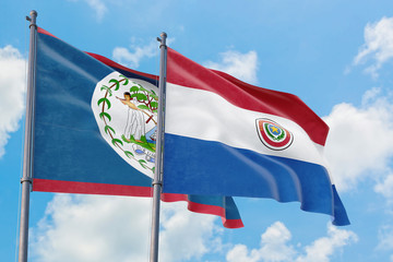 Paraguay and Belize flags waving in the wind against white cloudy blue sky together. Diplomacy concept, international relations.