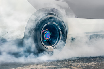 Drag racing car burns rubber off its tires in preparation for the race