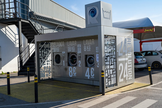 Armacao de Pera, Portugal - January 21, 2020:  Revolution 24 outdoor self-service laundry facilities placed outside of an Intermarche grocery storee