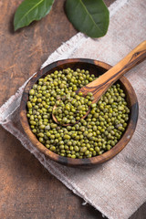 Green mung beans in bowl on wooden  background /  bean seed cereal whole grains