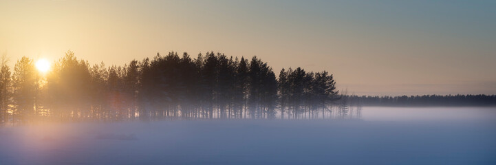 Sunset landscape on frozen winter lake in Finland