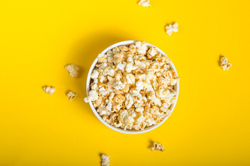Popcorn viewed from above on yellow background. Flat lay  bowl. Top view