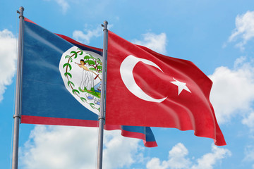 Turkey and Belize flags waving in the wind against white cloudy blue sky together. Diplomacy concept, international relations.