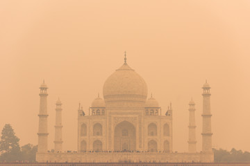 The backside of the Taj Mahal in Agra, India on overcast day with smog
