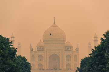 The backside of the Taj Mahal in Agra, India on overcast day with smog