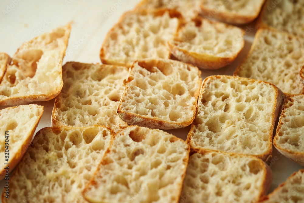 Sticker slicing bread half on cutting board