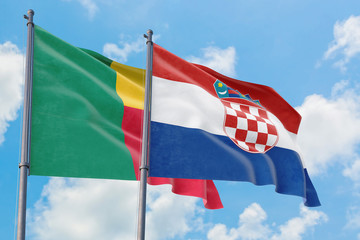 Croatia and Benin flags waving in the wind against white cloudy blue sky together. Diplomacy concept, international relations.