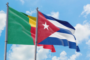 Fototapeta na wymiar Cuba and Benin flags waving in the wind against white cloudy blue sky together. Diplomacy concept, international relations.