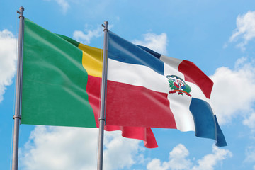 Dominican Republic and Benin flags waving in the wind against white cloudy blue sky together. Diplomacy concept, international relations.