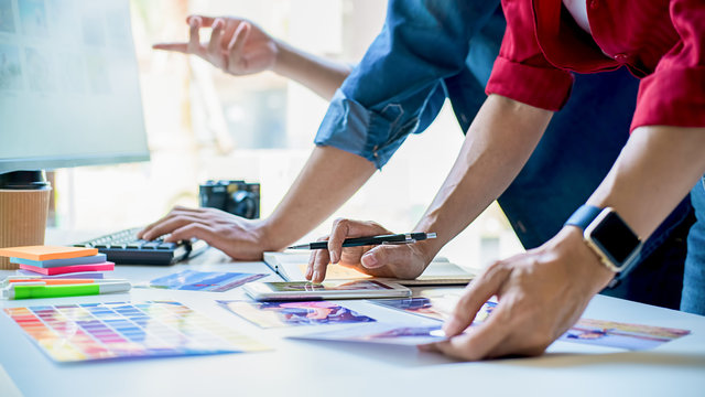 Advertising agency designer creative start-up team discussing ideas in office.