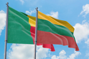 Lithuania and Benin flags waving in the wind against white cloudy blue sky together. Diplomacy concept, international relations.