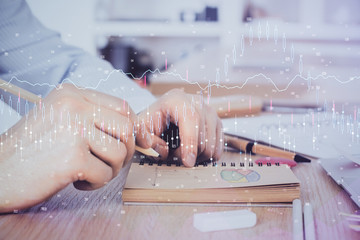 Multi exposure closeup hands with stock market forex graph.