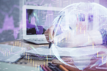 Financial forex charts displayed on woman's hand taking notes background. Concept of research. Double exposure