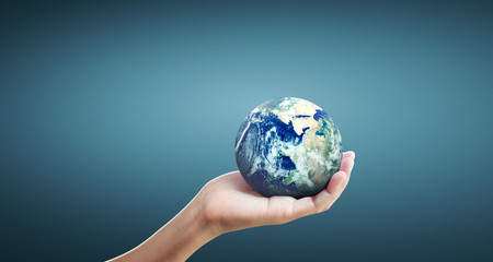 Globe ,earth in human hand, holding our planet glowing