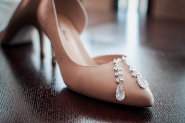 White high heel shoes with earrings