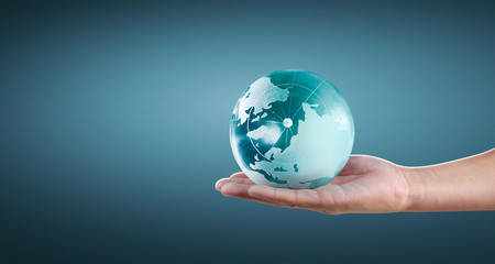 Globe ,earth in human hand, holding our planet glowing