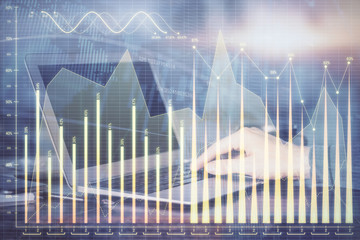 Double exposure of stock market graph with man working on laptop on background. Concept of...