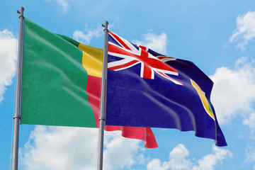 Turks And Caicos Islands and Benin flags waving in the wind against white cloudy blue sky together. Diplomacy concept, international relations.