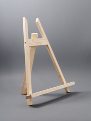 easel made of wood table on a gray background