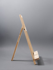 easel made of wood table on a gray background