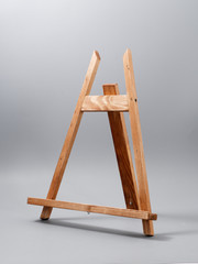 easel made of wood table on a gray background