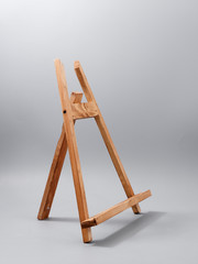 easel made of wood table on a gray background